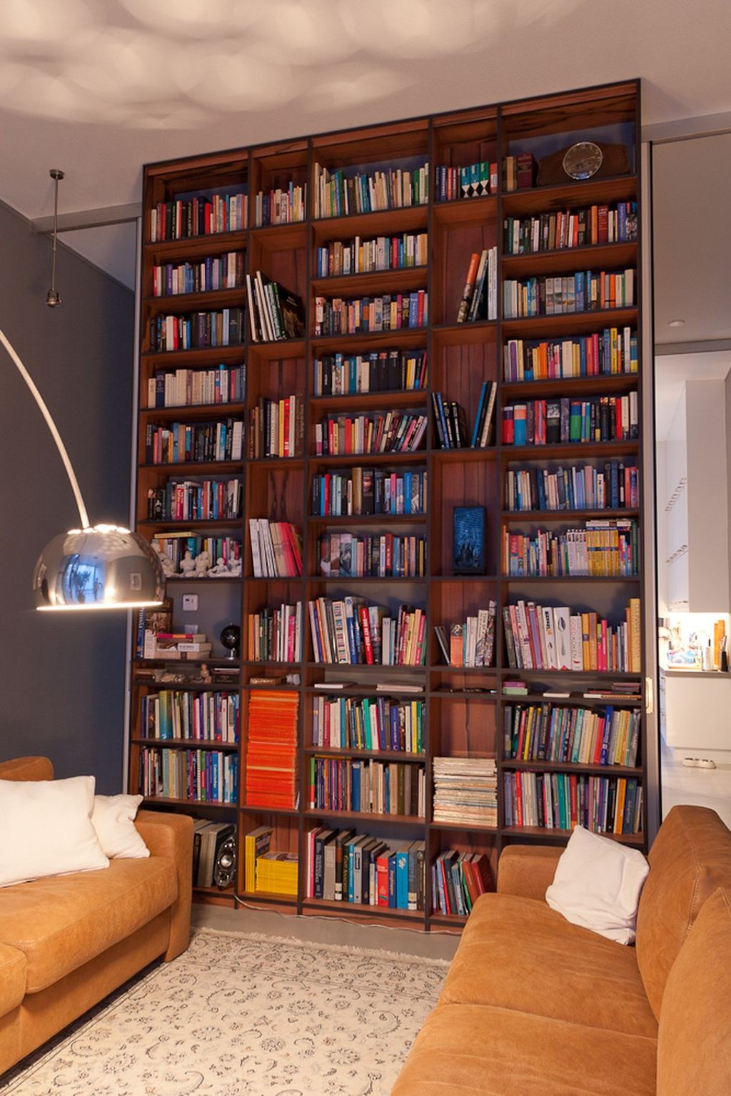 Wandvullende boekenkast in tyneo fineer, van vloer tot plafond.
